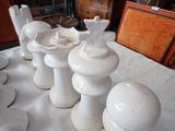 a lot of white vases sitting on a table
