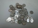 a pile of silver coins sitting on a table