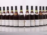 six bottles of wine lined up in a row on a table