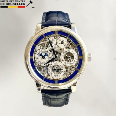 a close up of a wrist watch with a blue band