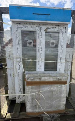 a small house that is on a pallet with a blue roof