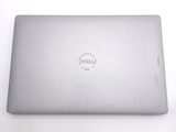 dell laptop computer sitting on a white surface with a dell logo on the screen