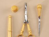 a pair of scissors, a comb, and a pair of scissors on a table