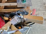 a bucket full of tools sitting on top of pallets