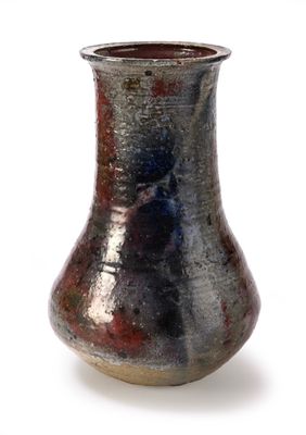 a vase that is sitting on a white surface