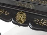 a black table with a gold design on it