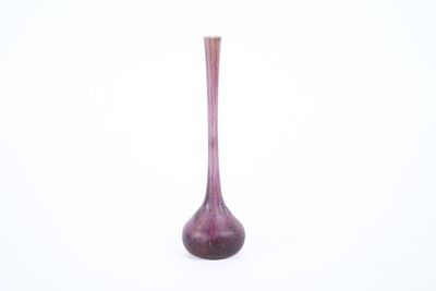 a purple vase that is sitting on a white surface
