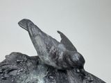 a statue of two birds sitting on top of each other