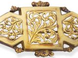 une image représentant une broche en or sur fond blanc