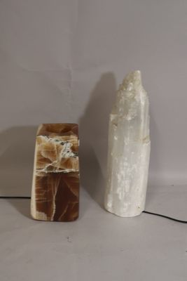 two different types of rocks on a white surface