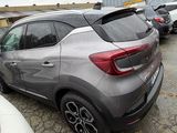 the rear end of a silver car parked in a parking lot