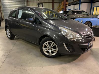 a picture of a grey car parked in a garage