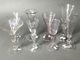 six wine glasses sitting next to each other on a table