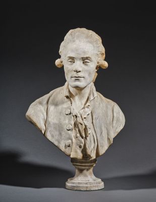 a white marble bust of a man wearing a suit and tie