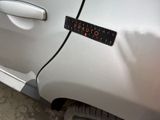 a sticker on the side of a white car