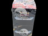 two boxes of pokemon trading cards sitting on top of each other