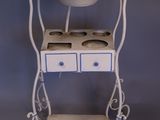 a small white table with two drawers and a sink