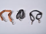 three different types of leather dog leashes on a white surface