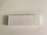 a small piece of white paper on a white surface