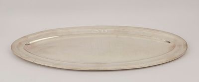 a silver plate on a white surface with a silver rim