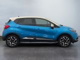 a blue and white renault c - hr suv parked in a parking lot