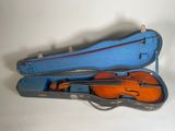 a violin in a blue case on a white surface