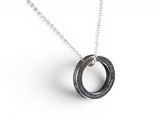 a close up of a necklace on a white surface with a chain