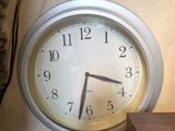 a clock that is on the wall next to a speaker