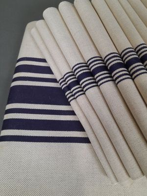 a stack of white and blue napkins on a table