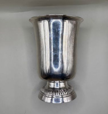 a silver vase that is on the wall