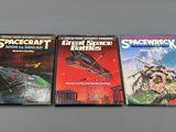 three books on a table with a space craft book in front of them