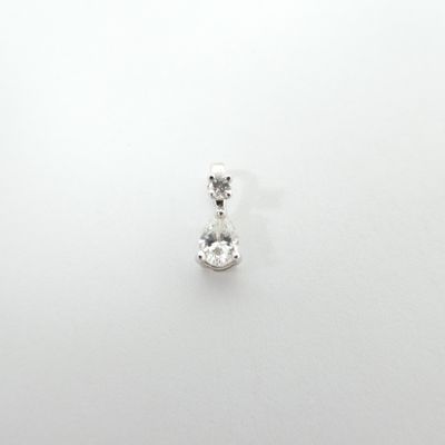 a close up of a single diamond pendant on a white surface