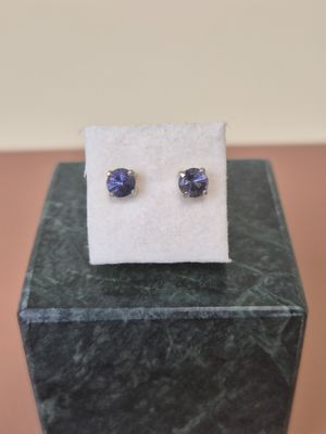 a close up of a pair of earrings sitting on top of a box