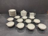 a lot of cups and saucers sitting on a table