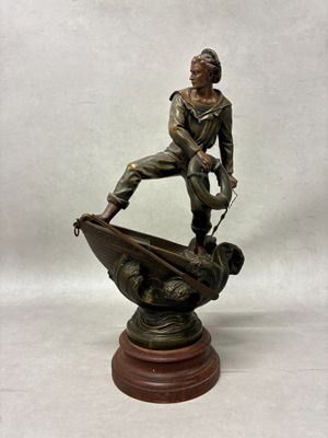 bronze statue of a man on a boat with a dog on it