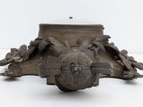 a metal object that is sitting on a white surface