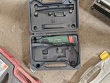 a tool in a case on the floor next to other tools