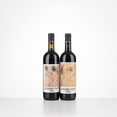 two bottles of wine sitting on top of a table next to each other