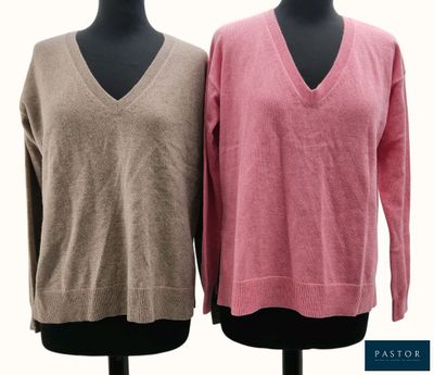 two women ' s v - neck sweaters on a mannequin stand