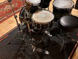 a drum set up in a recording studio with a microphone