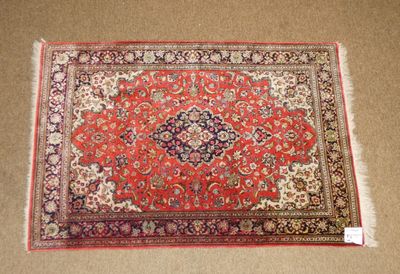 a red rug with a medallion design on it
