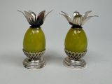 two silver and green vases with flowers on them
