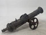 an old cannon sitting on top of a white surface