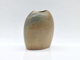 a small vase that is sitting on a white surface