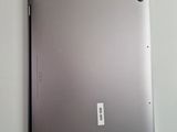 a silver laptop with a white cord attached to it