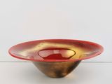 an image of a red and gold bowl on a white surface
