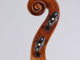 an antique violin with a wooden back and a scroll