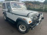 a white jeep that is parked in the parking lot