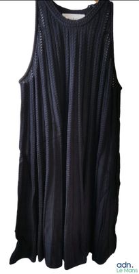 the tank top is black and has holes on it