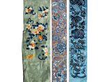 three different colored scarfs with floral designs on them on a white background
